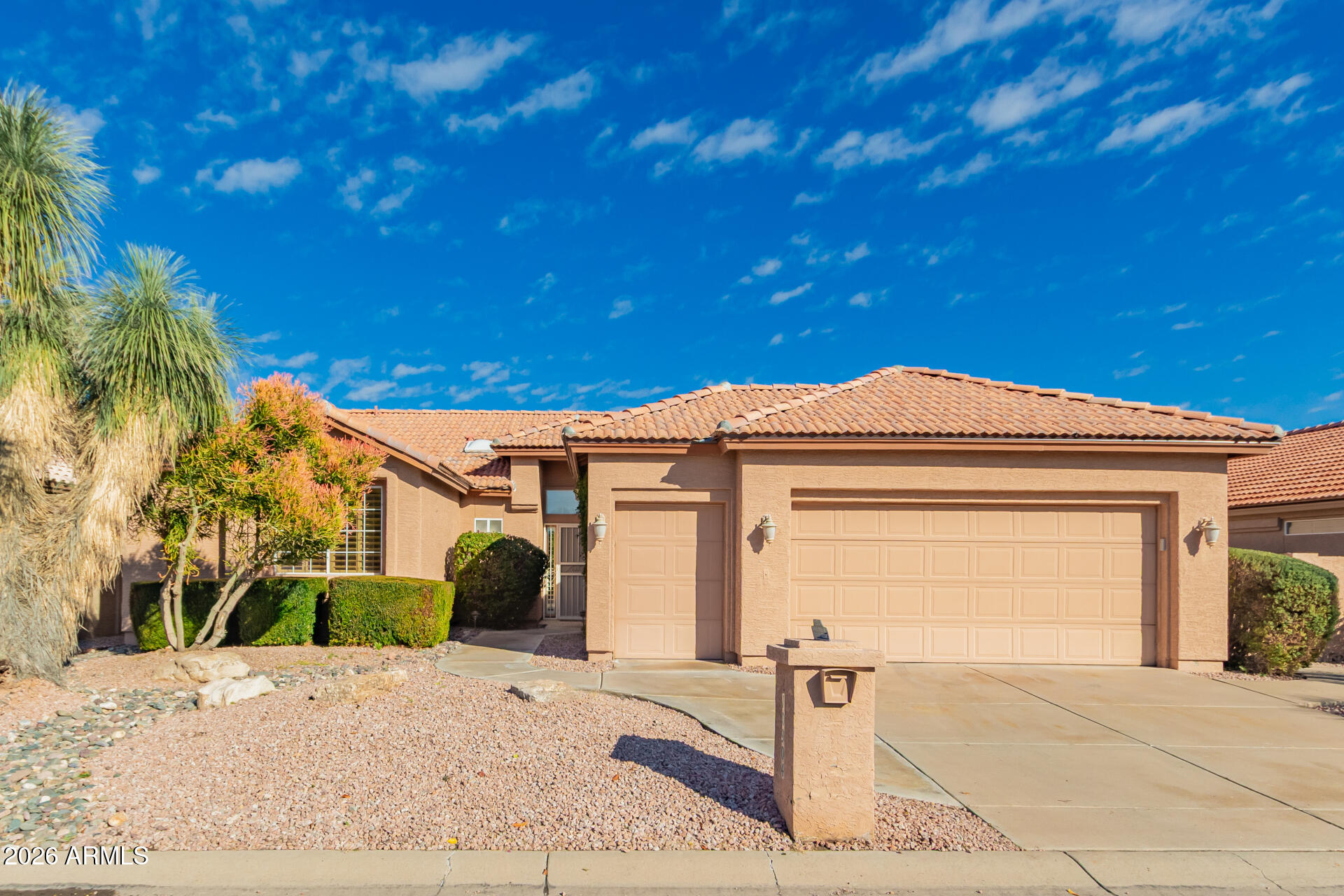 10904 East Spring Creek Road Sun Lakes, AZ 85248 - Photo 2 of 37 a front view of a house with a yard