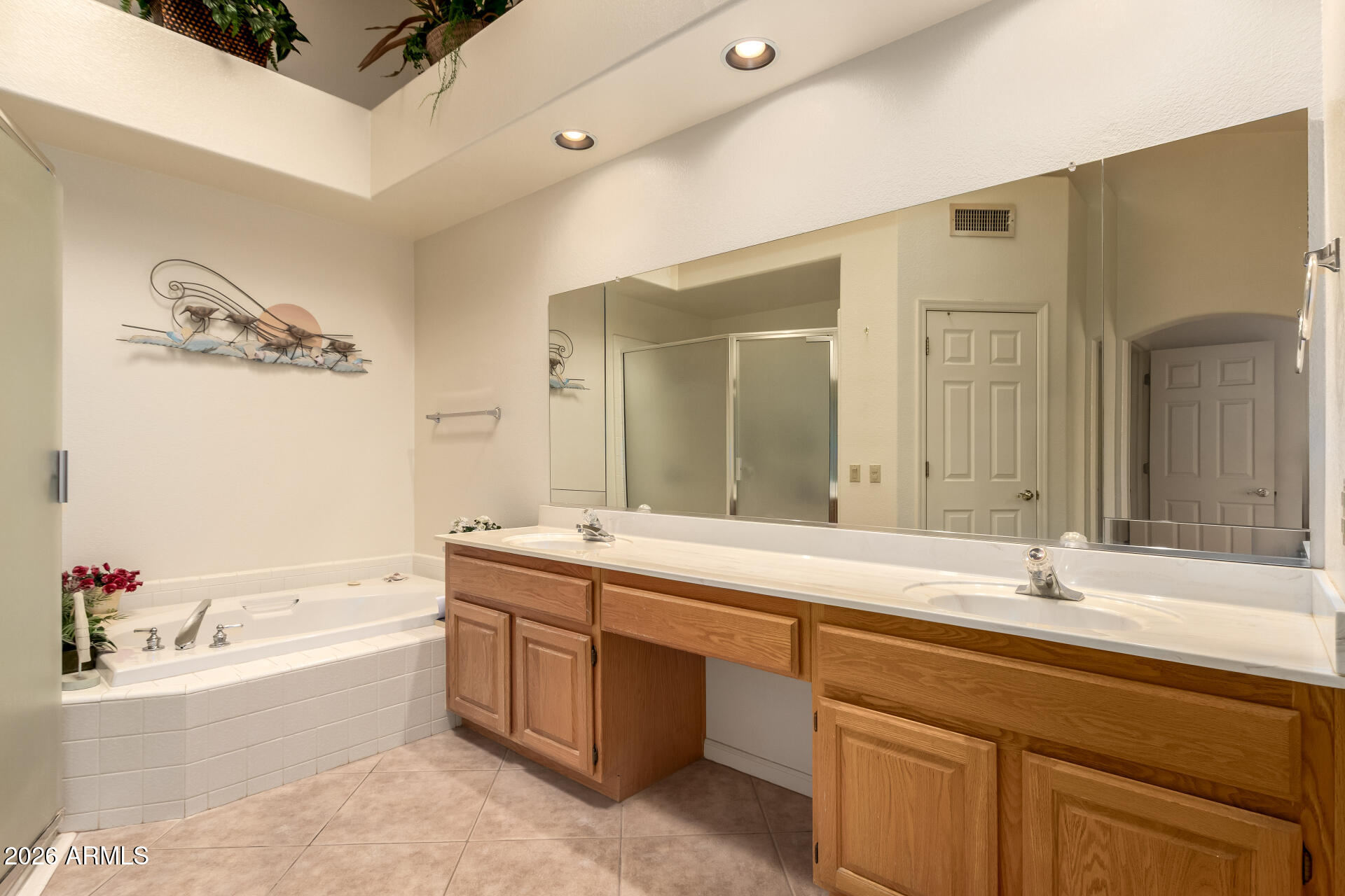 10904 East Spring Creek Road Sun Lakes, AZ 85248 - Photo 24 of 37 a bathroom with a tub sink and mirror