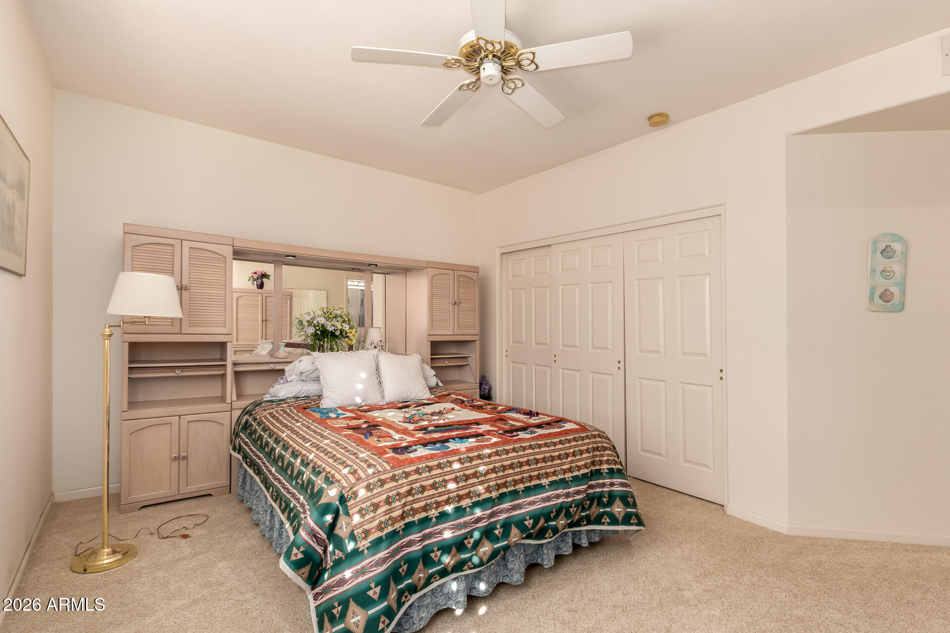 10904 East Spring Creek Road Sun Lakes, AZ 85248 - Photo 27 of 37 a bedroom with a bed and a chandelier