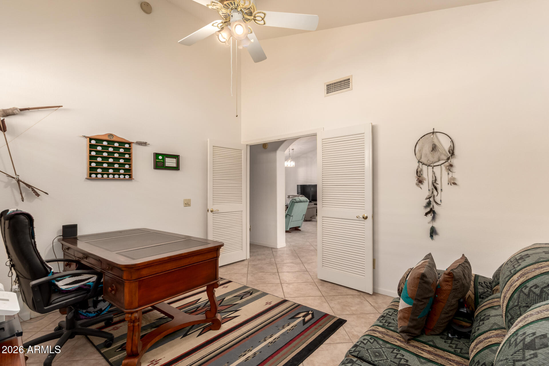 10904 East Spring Creek Road Sun Lakes, AZ 85248 - Photo 30 of 37 a living room with a piano and a table