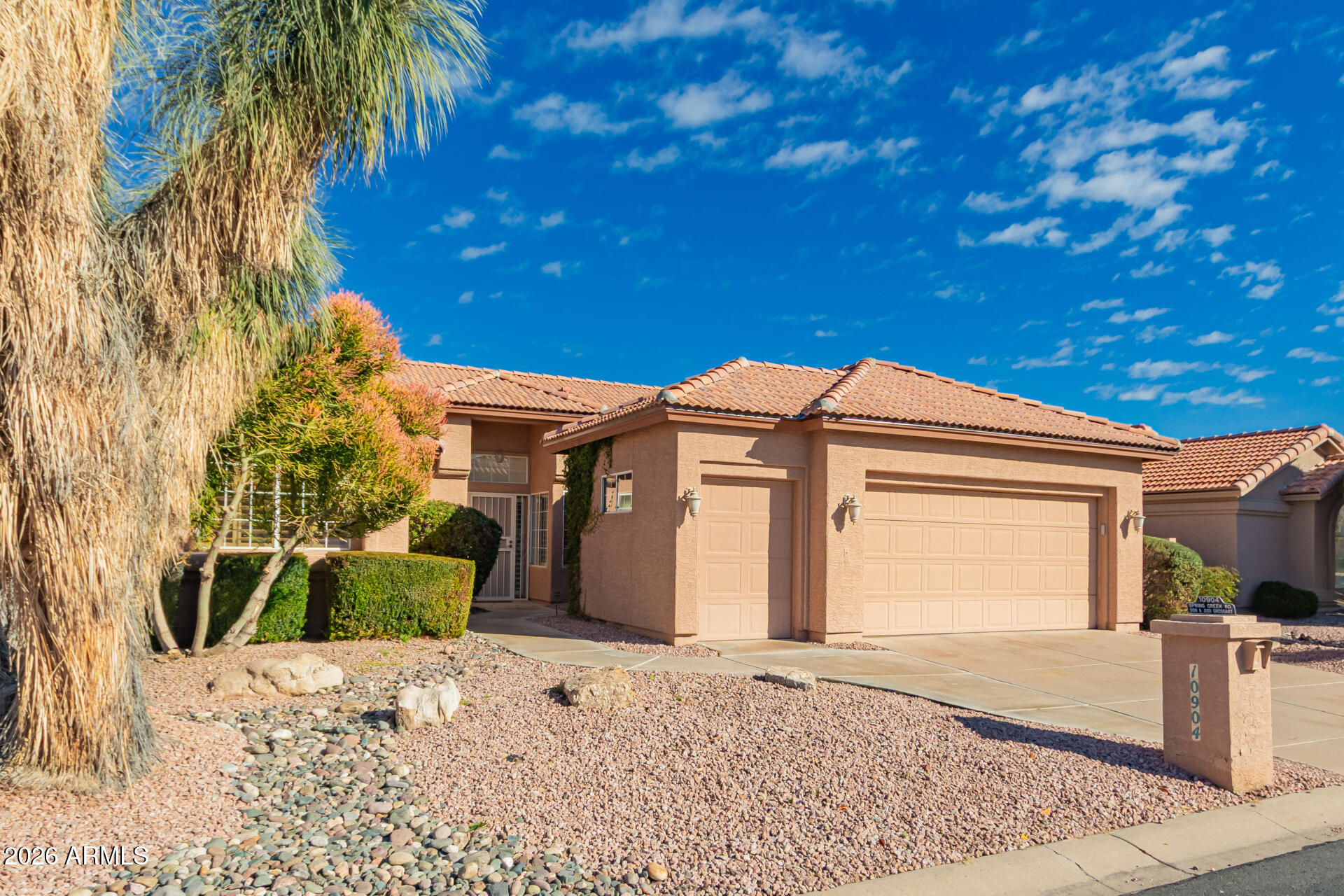 10904 East Spring Creek Road Sun Lakes, AZ 85248 - Photo 3 of 37 a front view of a house with a garden