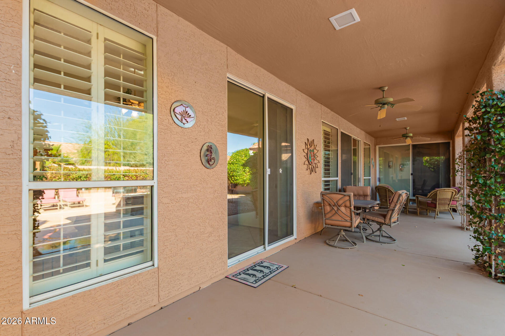 10904 East Spring Creek Road Sun Lakes, AZ 85248 - Photo 32 of 37 a building outdoor space with patio furniture and potted plants