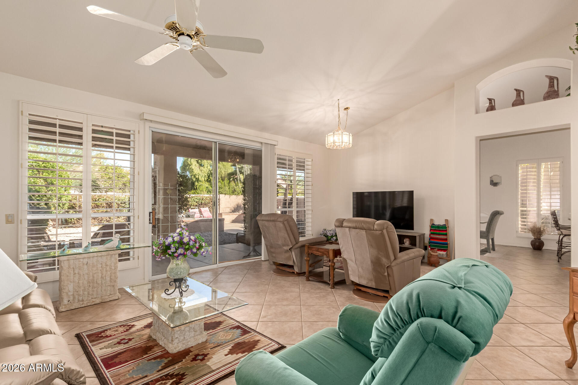 10904 East Spring Creek Road Sun Lakes, AZ 85248 - Photo 7 of 37 a living room with furniture a flat screen tv and a large window