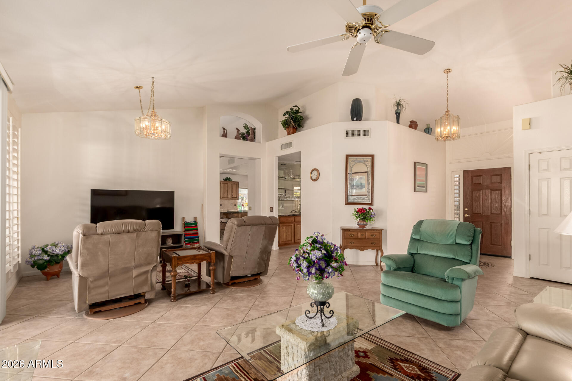 10904 East Spring Creek Road Sun Lakes, AZ 85248 - Photo 8 of 37 a living room with furniture and a chandelier