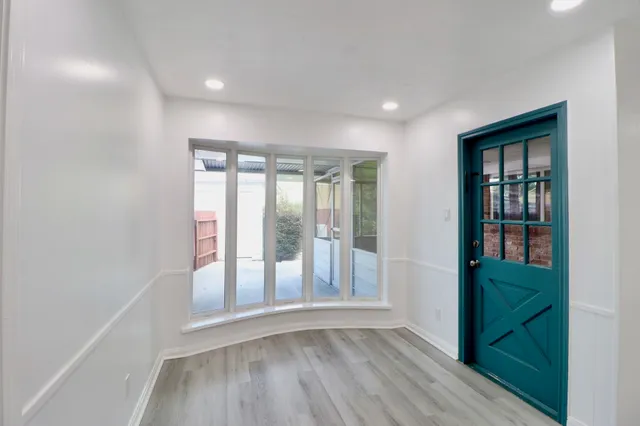 wooden floor in an empty room with a window