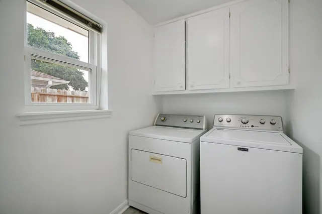 a view of storage and utility room with washer and dryer