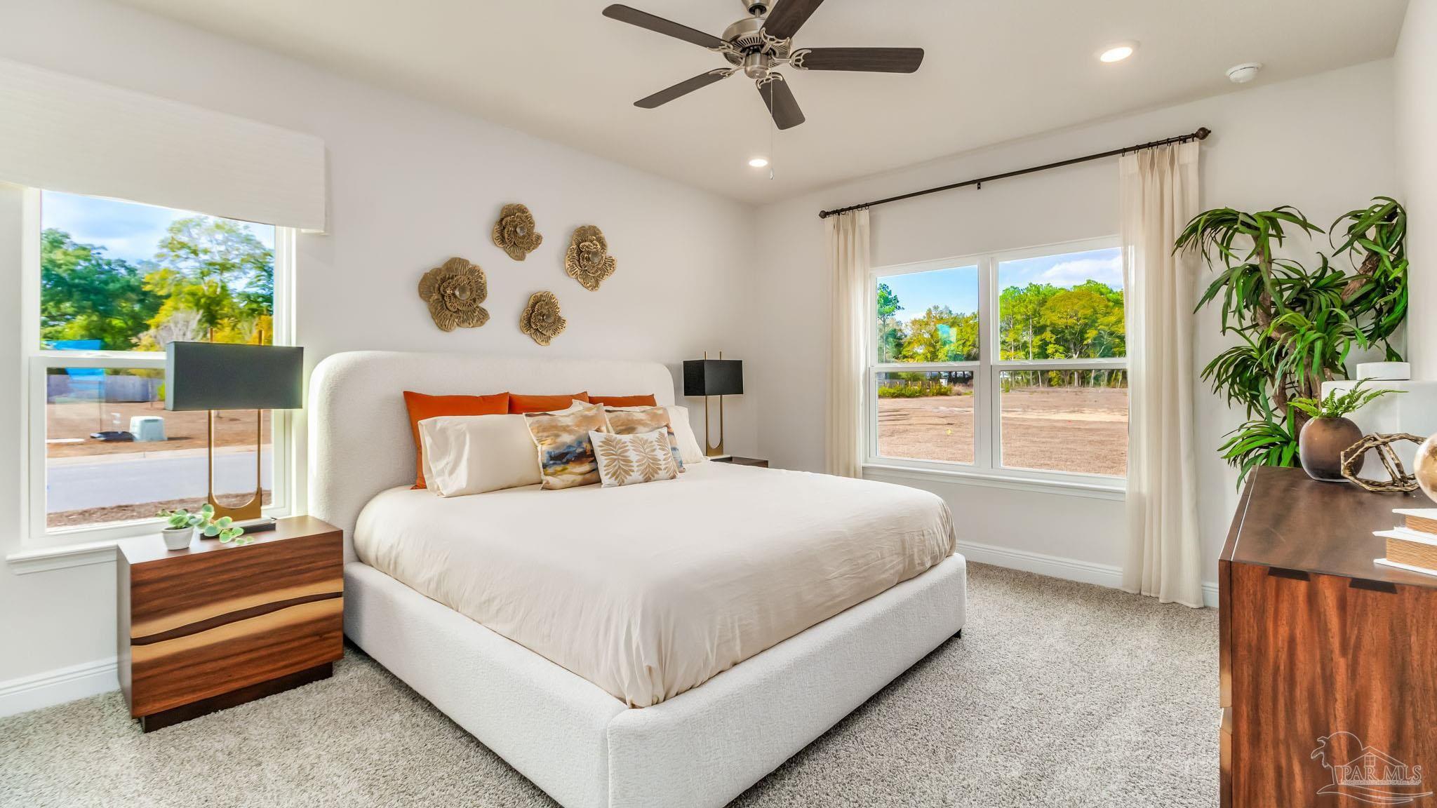 8685 Bluebell Street Milton, FL 32583 - Photo 13 of 30 a bedroom with a large bed and a potted plant