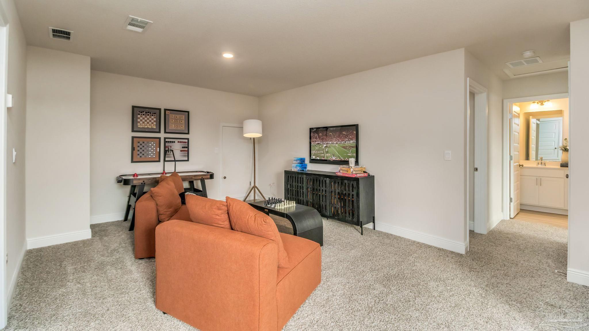 8685 Bluebell Street Milton, FL 32583 - Photo 22 of 30 a living room with furniture and a flat screen tv