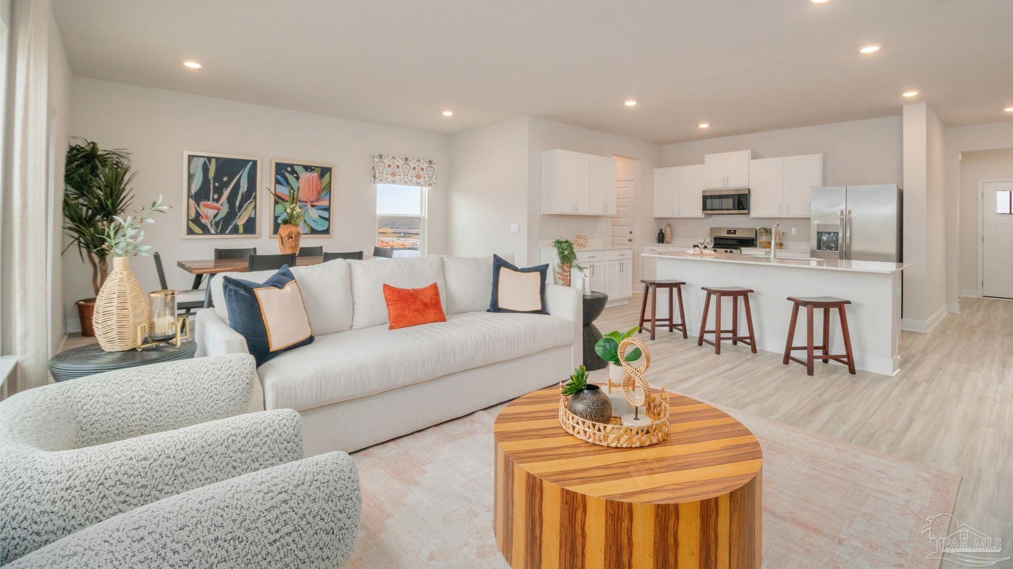 8685 Bluebell Street Milton, FL 32583 - Photo 3 of 30 a living room with furniture kitchen and a table