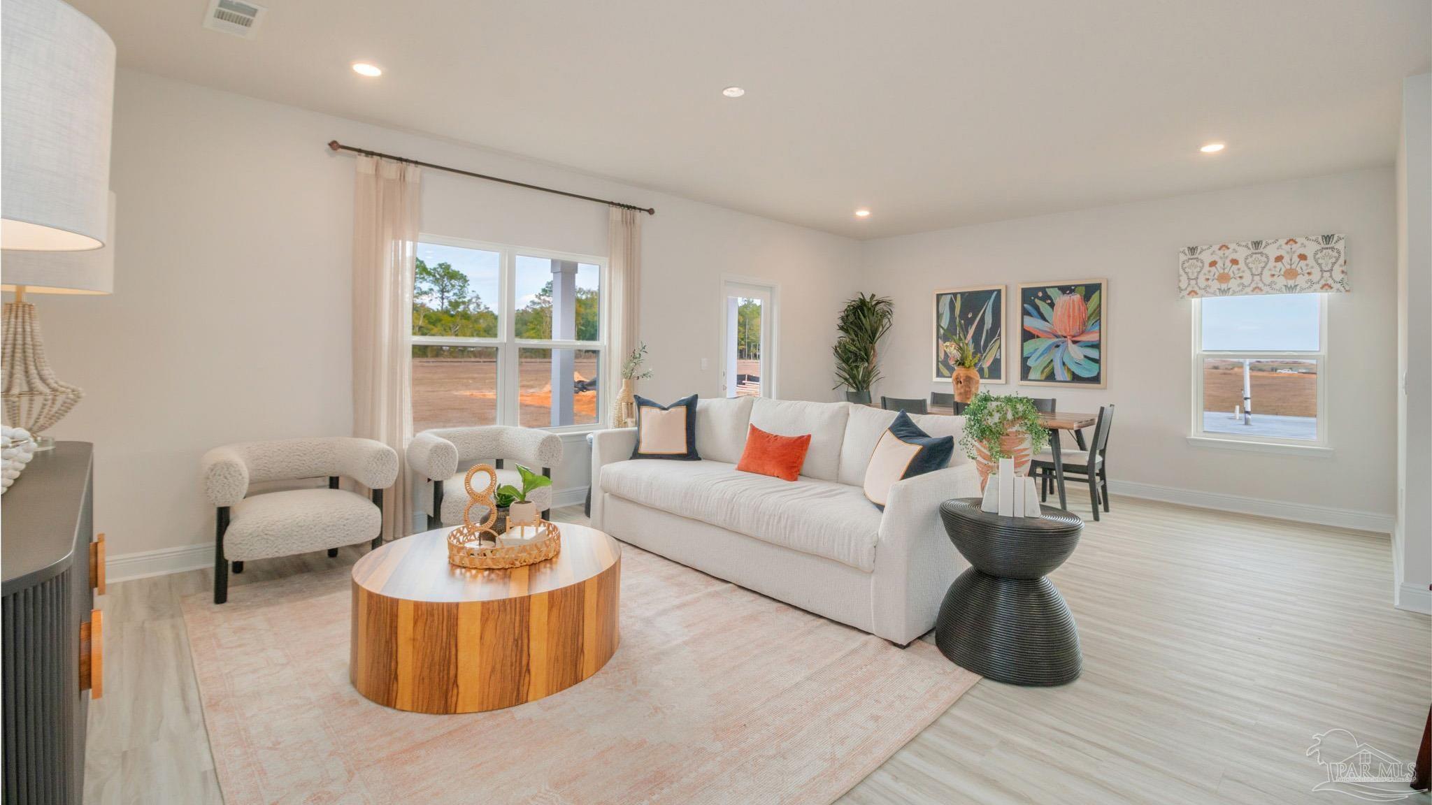 8685 Bluebell Street Milton, FL 32583 - Photo 10 of 30 a living room with furniture and a table