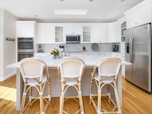 4 Sayles Road Hingham, MA 02043 - Photo 3 of 35 a kitchen with stainless steel appliances granite countertop a dining table chairs refrigerator and sink