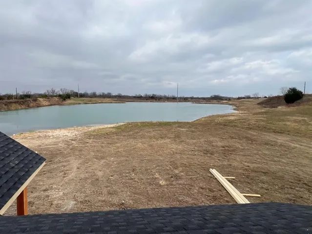 a view of a lake with houses in the back