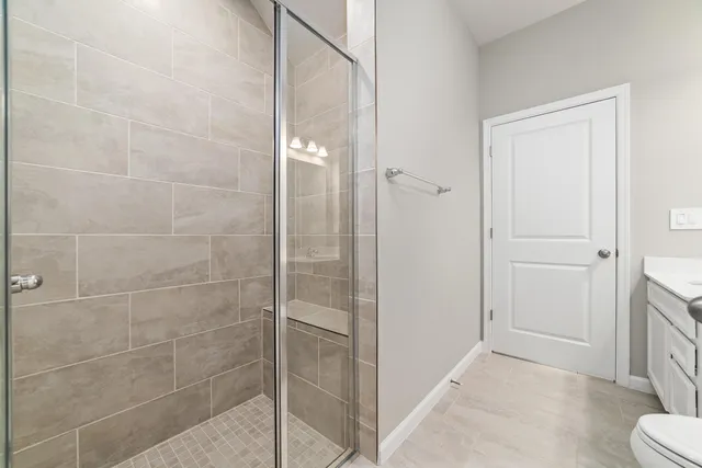 a bathroom with a shower and toilet