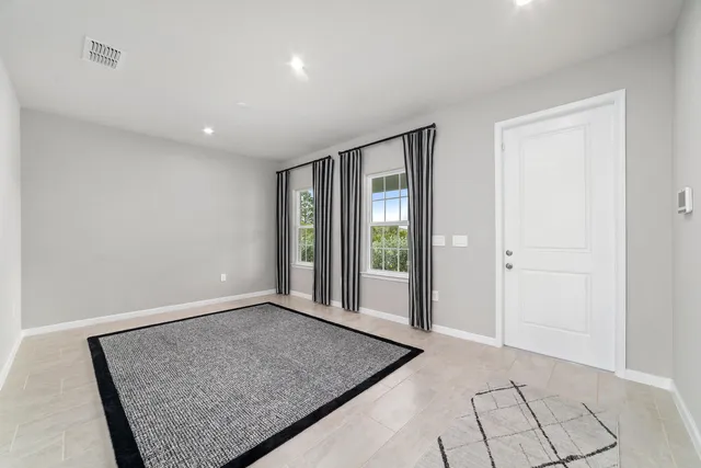 a view of an empty room with glass door