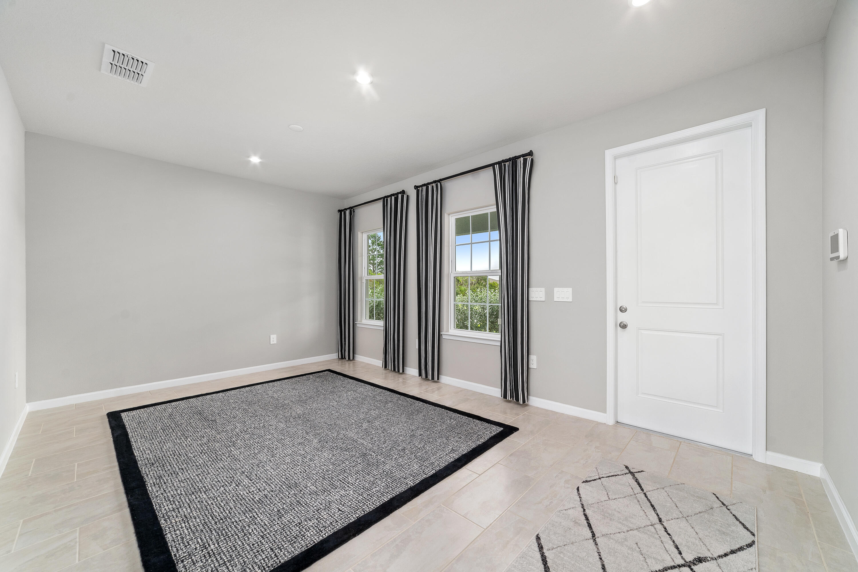 6555 Pomello Court Vero Beach, FL 32967 - Photo 4 of 35 a view of an empty room with glass door