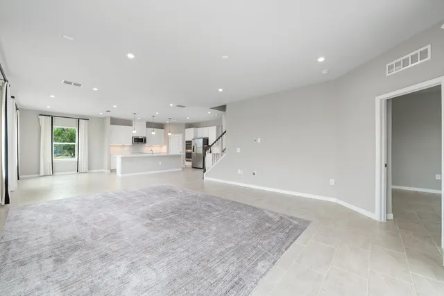 a view of kitchen with kitchen island and stainless steel appliances