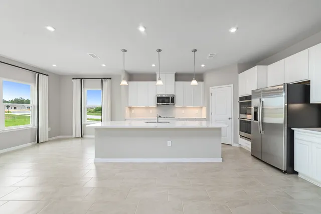 a large kitchen with stainless steel appliances kitchen island granite countertop a large counter top stainless steel appliances and cabinets