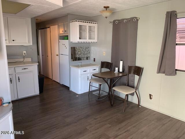 a living room with stainless steel appliances granite countertop furniture wooden floor and a kitchen view