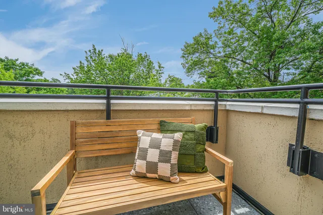 a view of a balcony with wooden floor and fence