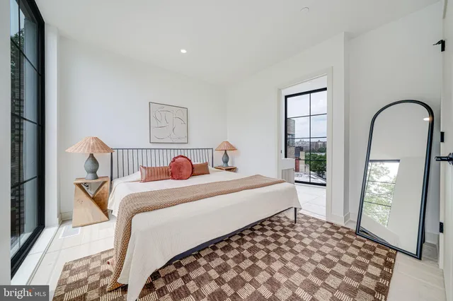 a bedroom with a large bed and a window