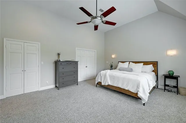 a spacious bedroom with a bed and cabinet