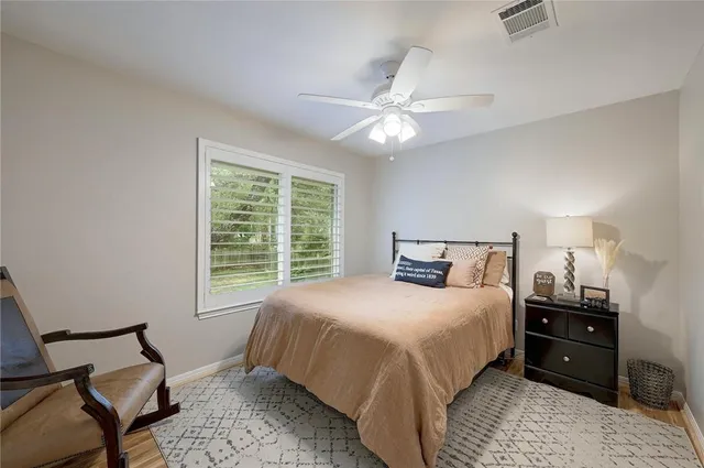 a bedroom with a large bed and a window