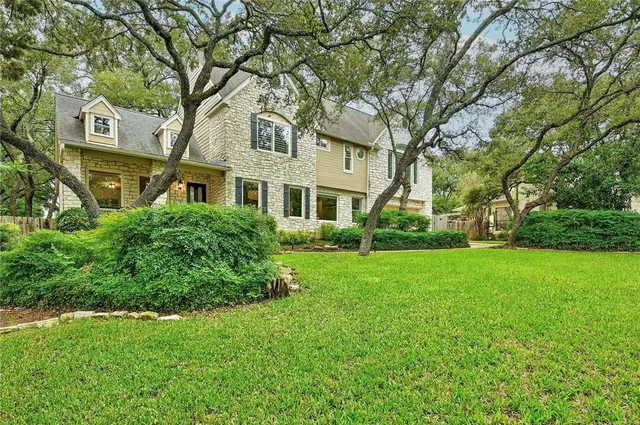 a view of backyard of house with green space