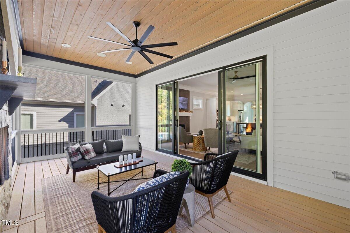 3418 Edgemont Drive Raleigh, NC 27612 - Photo 16 of 52 a living room with furniture a ceiling fan and a rug