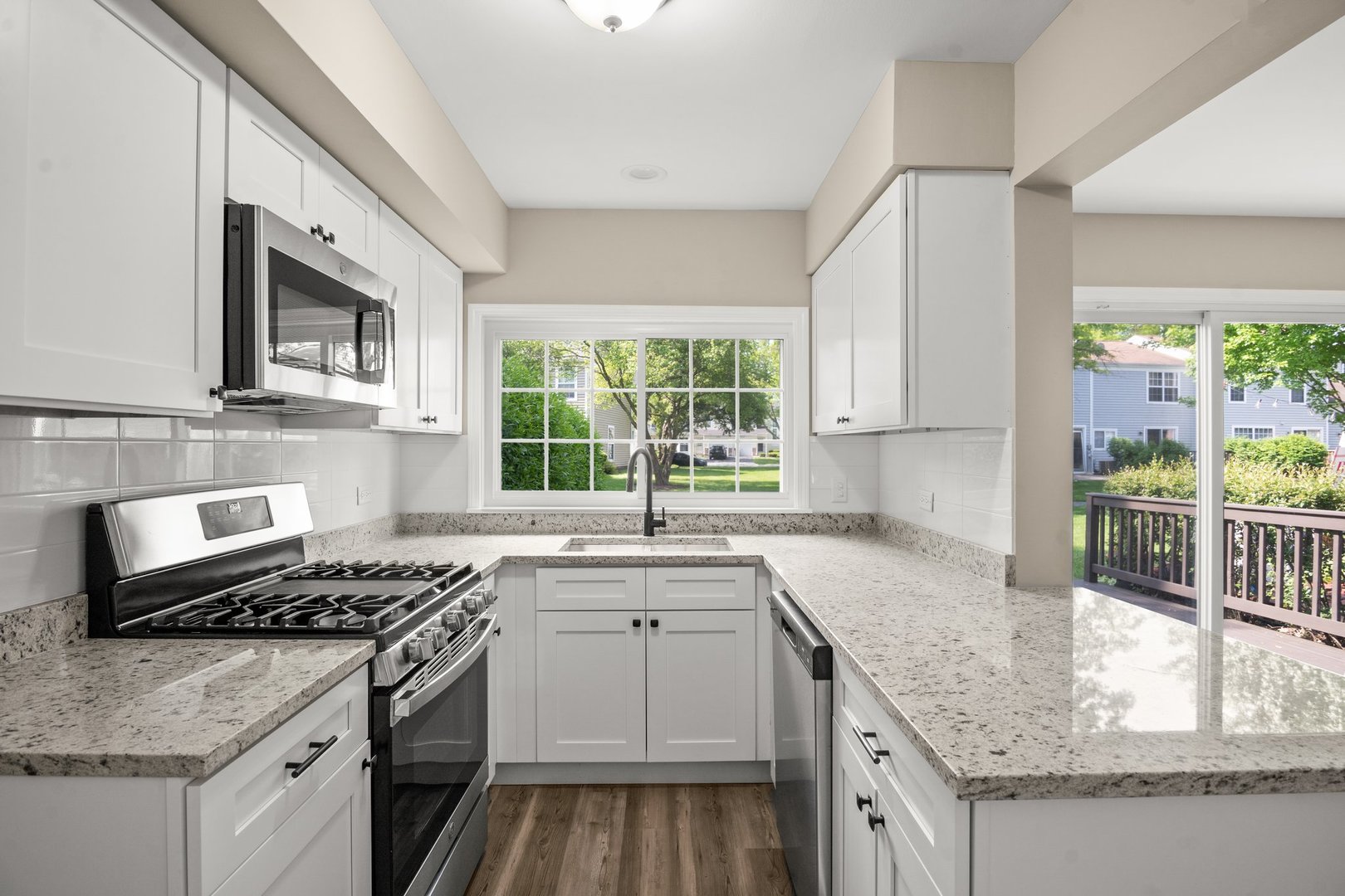 1673 Pebble Beach Circle Elgin, IL 60123 - Photo 11 of 25 a kitchen with granite countertop a sink stove and cabinets