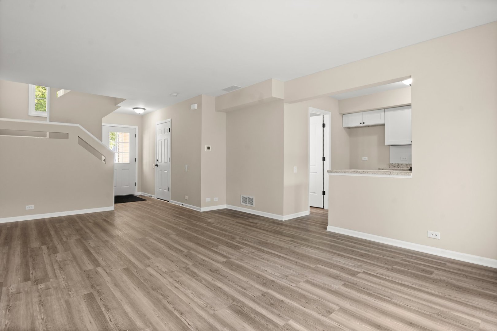 1673 Pebble Beach Circle Elgin, IL 60123 - Photo 6 of 25 an empty room with wooden floor and windows