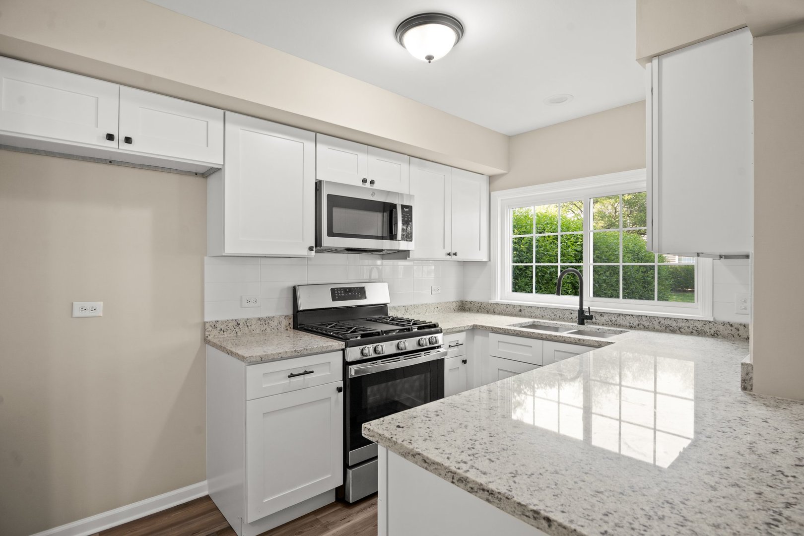 1673 Pebble Beach Circle Elgin, IL 60123 - Photo 9 of 25 a kitchen with a stove a sink and a microwave