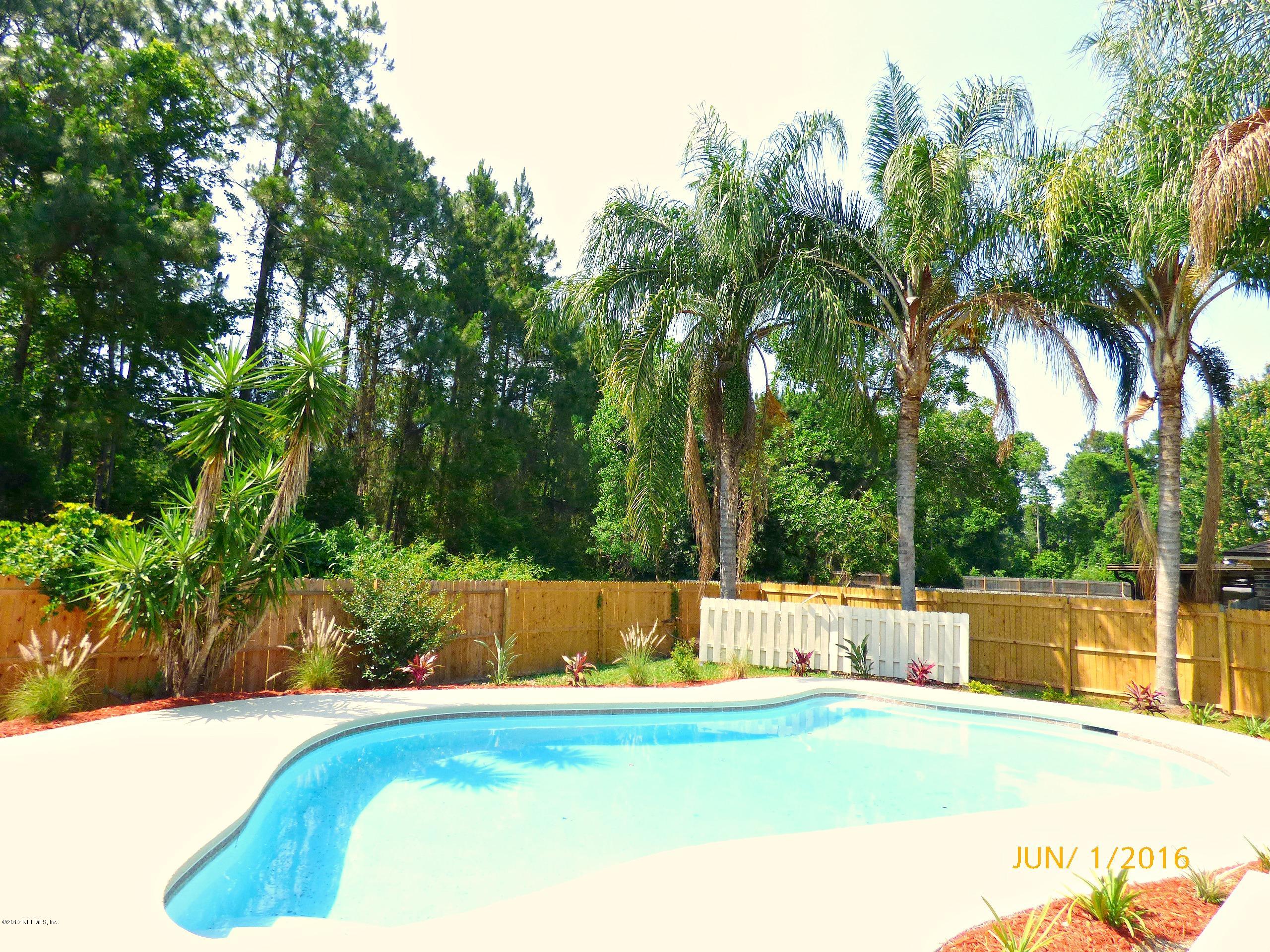 1218 Raleigh Ridge Drive Jacksonville, FL 32225 - Photo 1 of 14 a view of a swimming pool with a yard