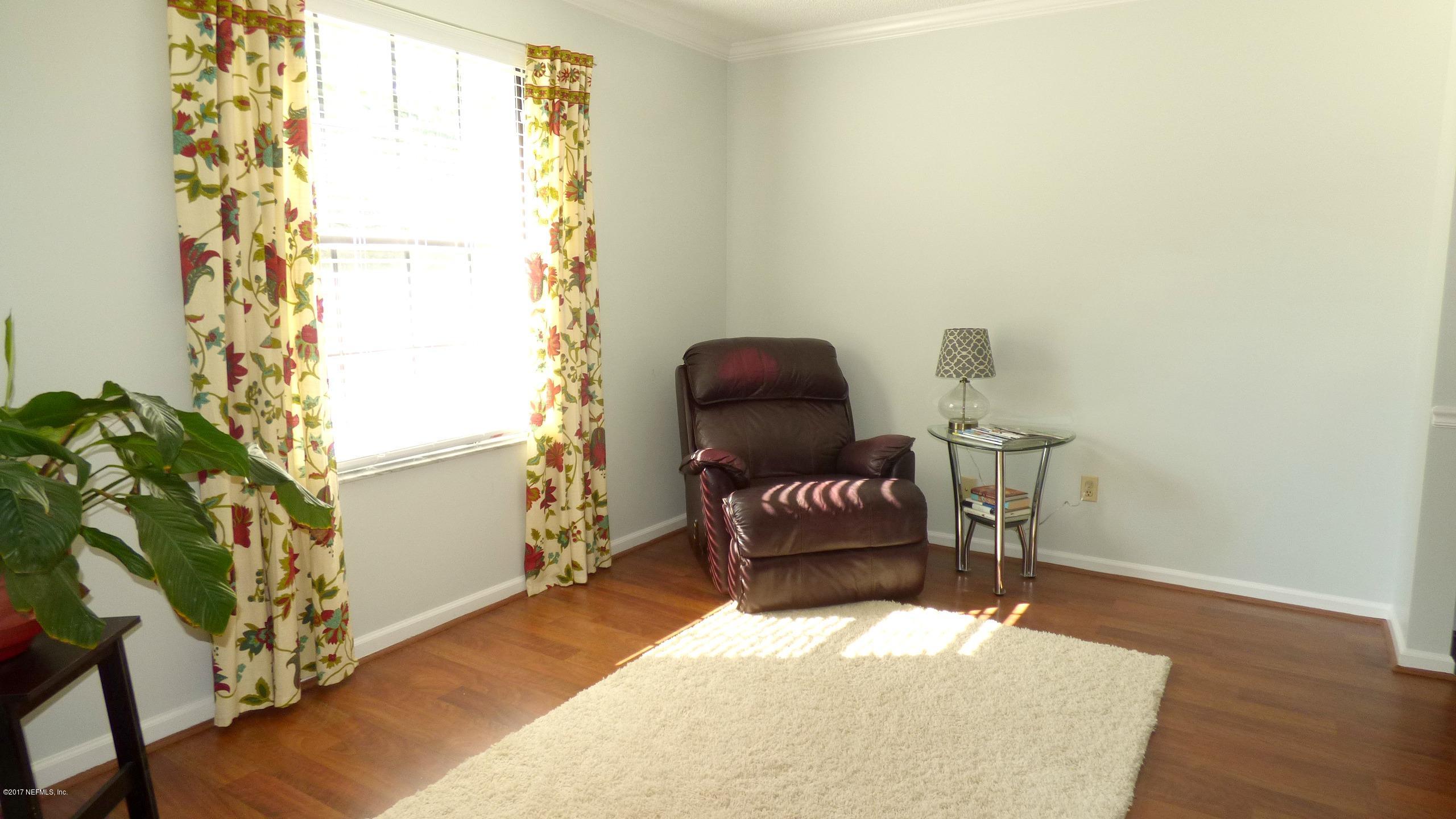 1218 Raleigh Ridge Drive Jacksonville, FL 32225 - Photo 12 of 14 a chair and a table in a room