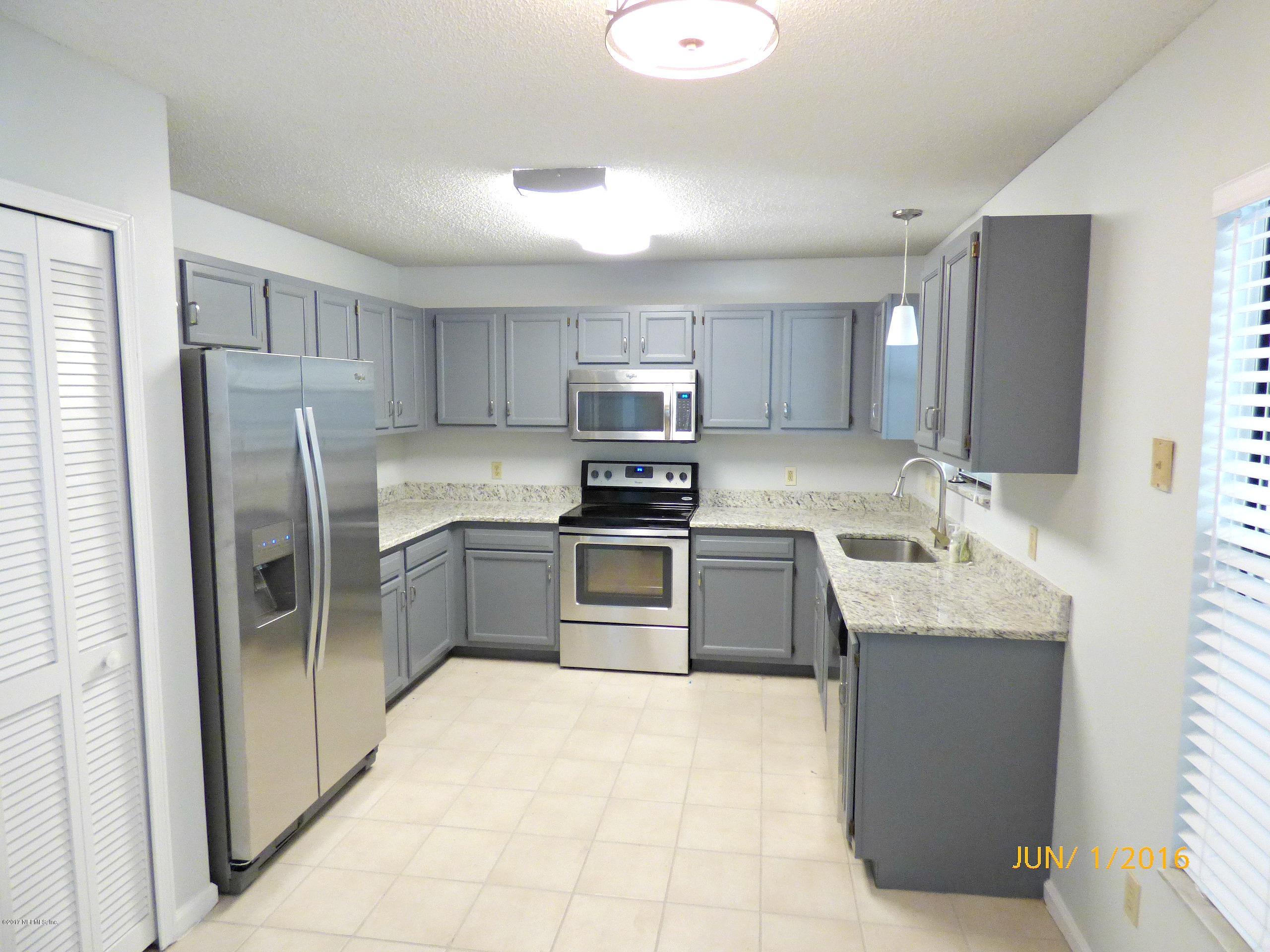 1218 Raleigh Ridge Drive Jacksonville, FL 32225 - Photo 2 of 14 a kitchen with stainless steel appliances granite countertop a refrigerator sink and stove