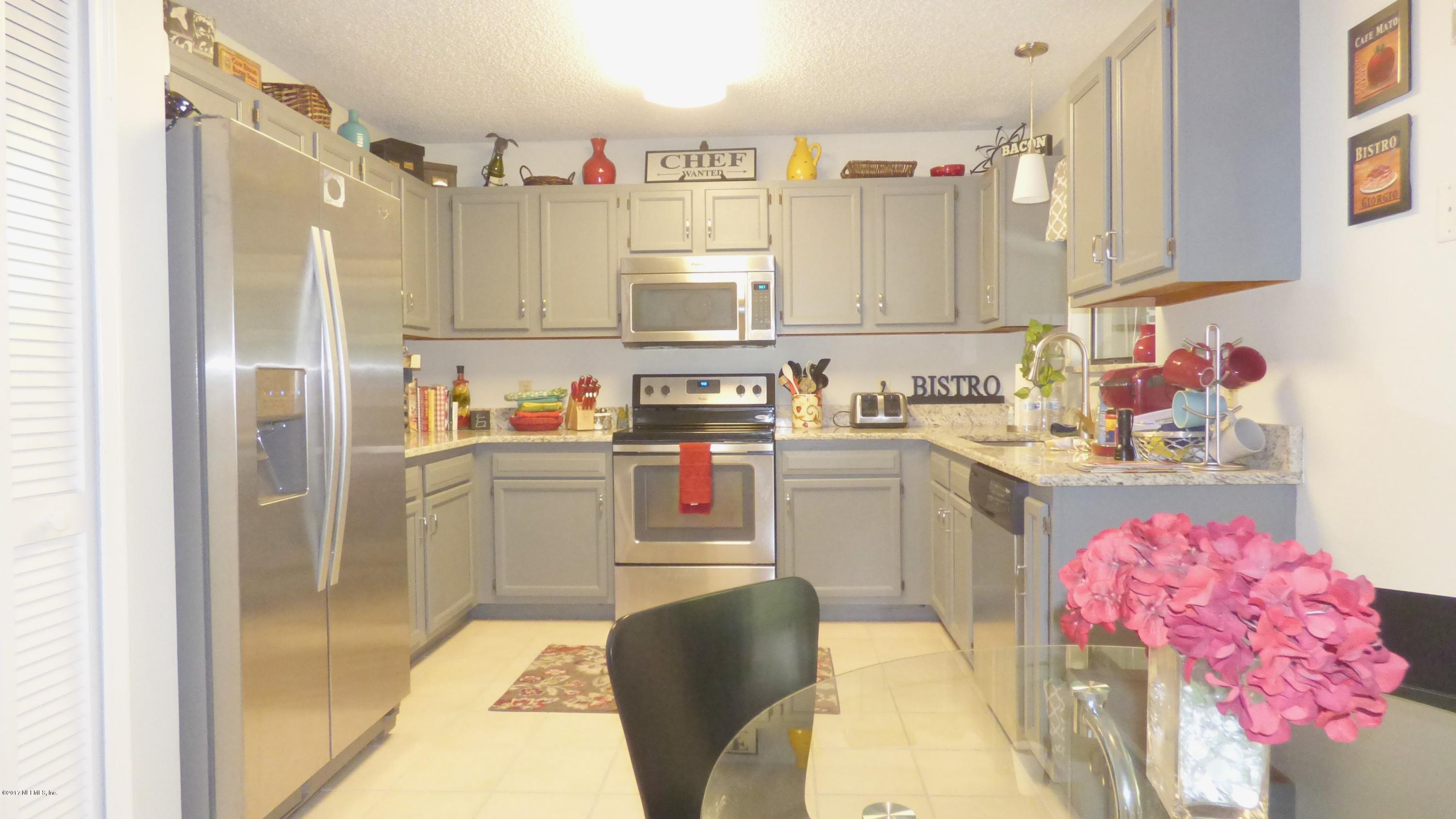 1218 Raleigh Ridge Drive Jacksonville, FL 32225 - Photo 3 of 14 a kitchen with a sink dishwasher stove and refrigerator