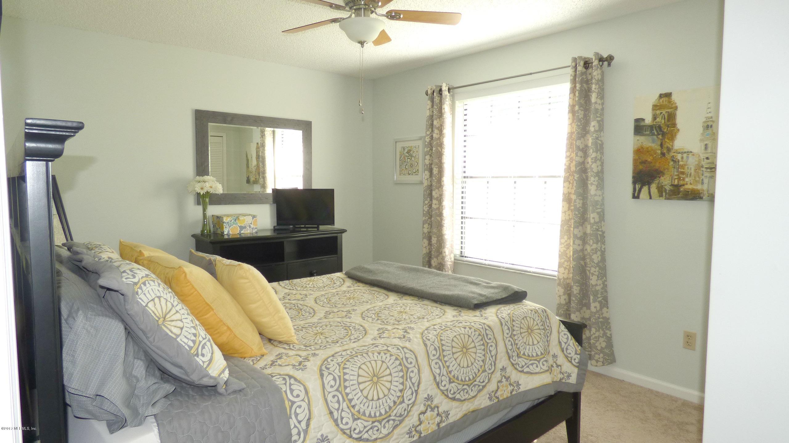 1218 Raleigh Ridge Drive Jacksonville, FL 32225 - Photo 8 of 14 a bedroom with a bed and wooden floor