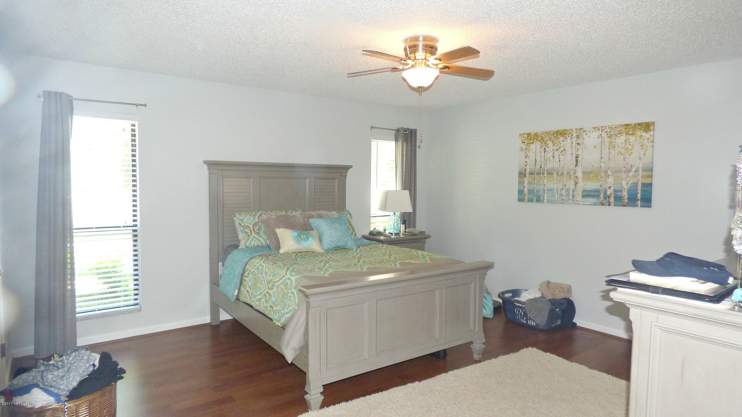 1218 Raleigh Ridge Drive Jacksonville, FL 32225 - Photo 9 of 14 a bedroom with a bed and a chandelier