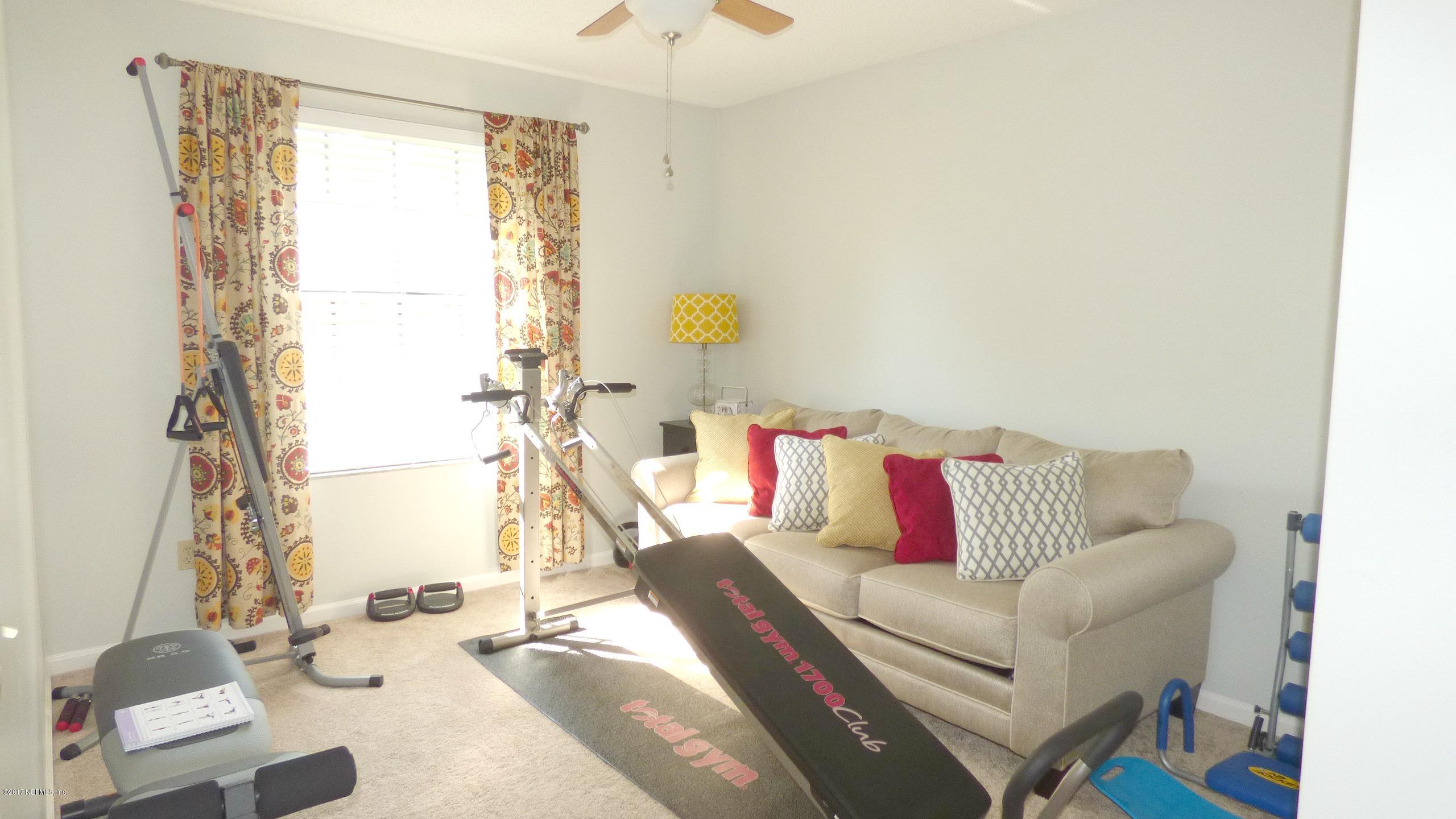 1218 Raleigh Ridge Drive Jacksonville, FL 32225 - Photo 10 of 14 a living room with furniture and a table