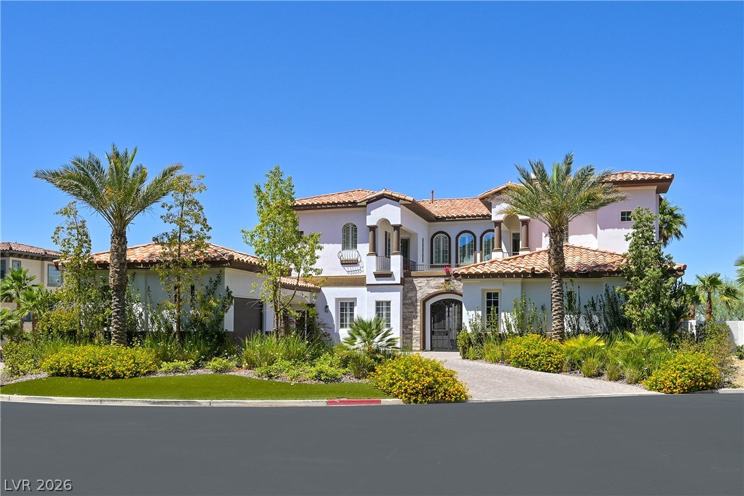 6 Rue Du Ville Henderson, NV 89011 - Photo 88 of 99 This Mediterranean-inspired home boasts an elegant facade with lush, verdant landscaping.