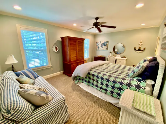 a bedroom with a bed a window and a chandelier