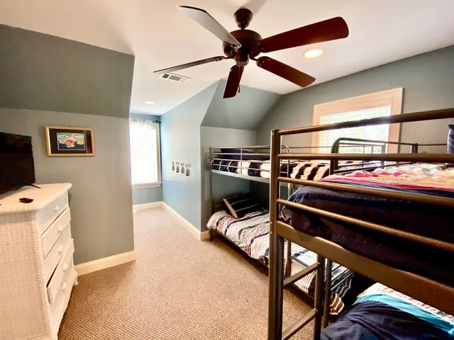 a bedroom with furniture and a ceiling fan