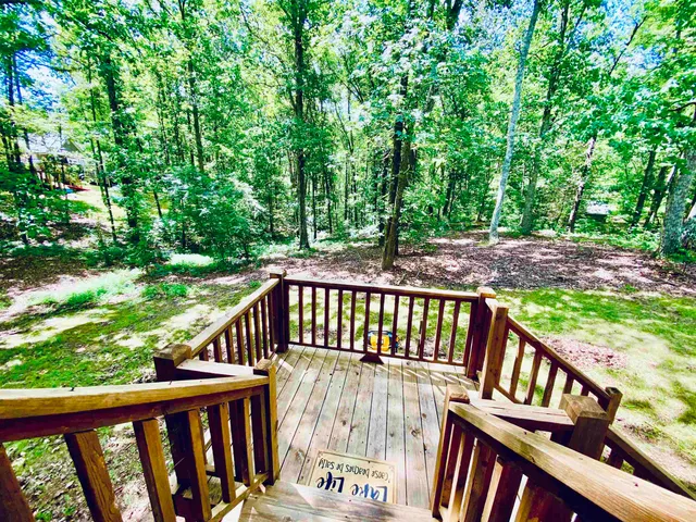 a view of a wooden deck with a trees