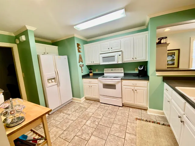a kitchen with a refrigerator sink and stove