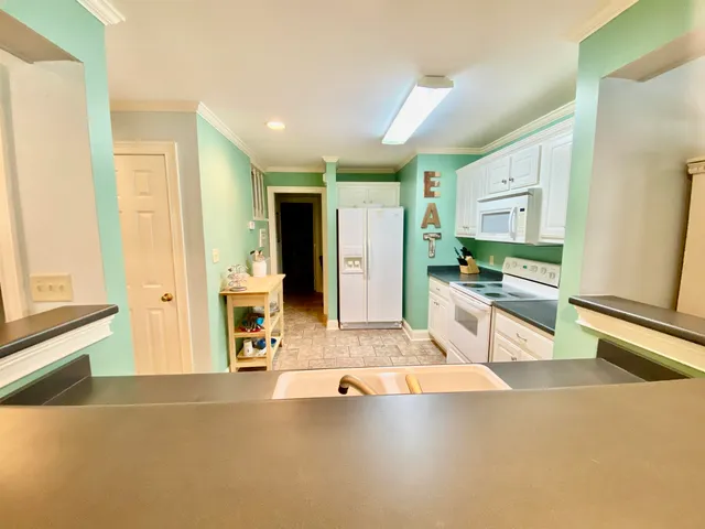 a large kitchen with stainless steel appliances a large counter top and a stove