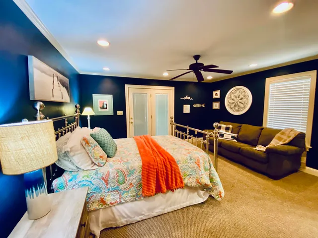 a bed room with a bed mirror and a chandelier