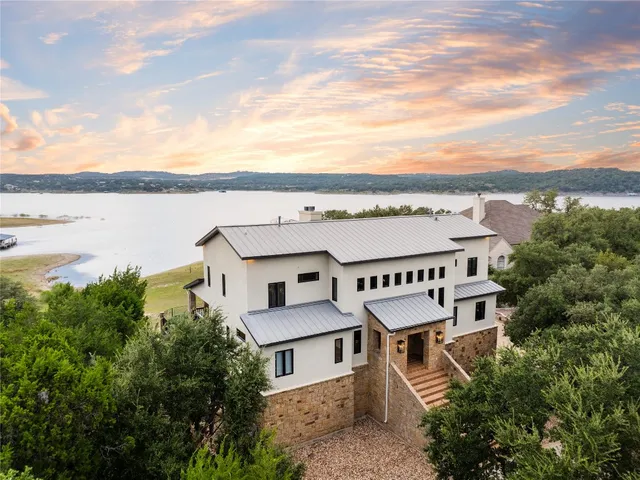 a front view of a house with swimming pool having outdoor seating