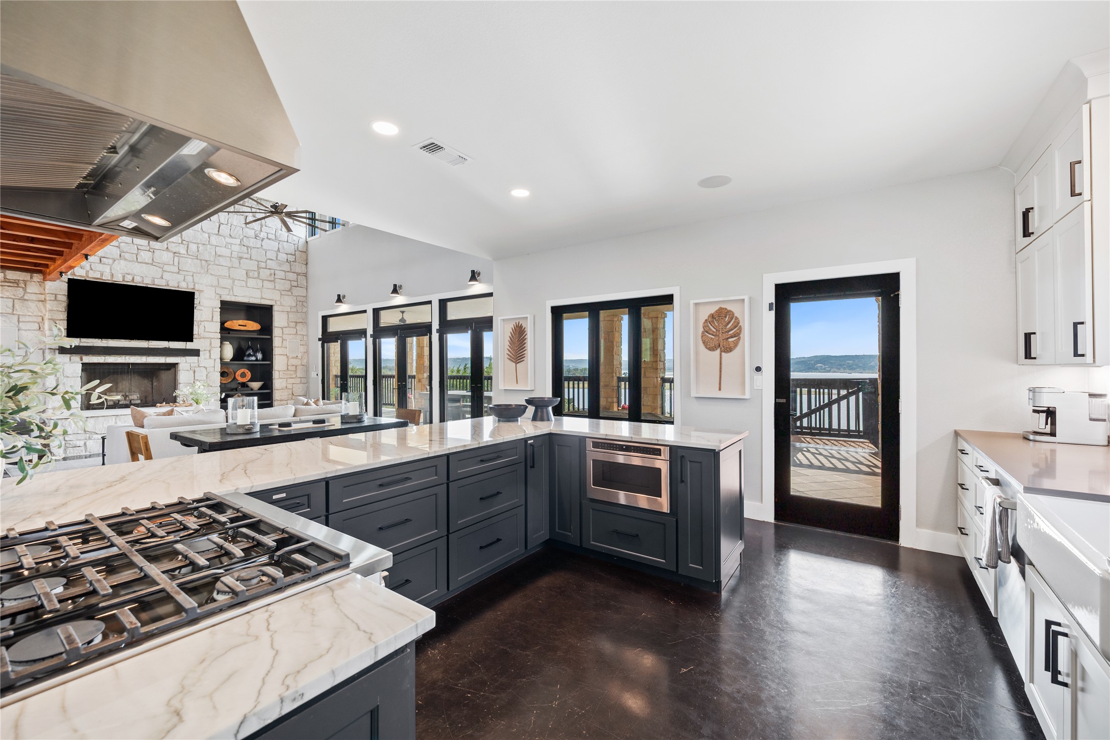 516 Deckhouse Drive Point Venture, TX 78645 - Photo 11 of 36 a large kitchen with stainless steel appliances granite countertop a stove and a sink