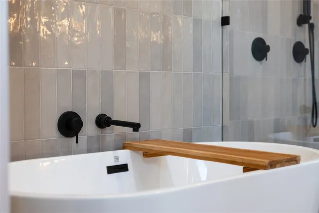 a bedroom with two beds and a large window