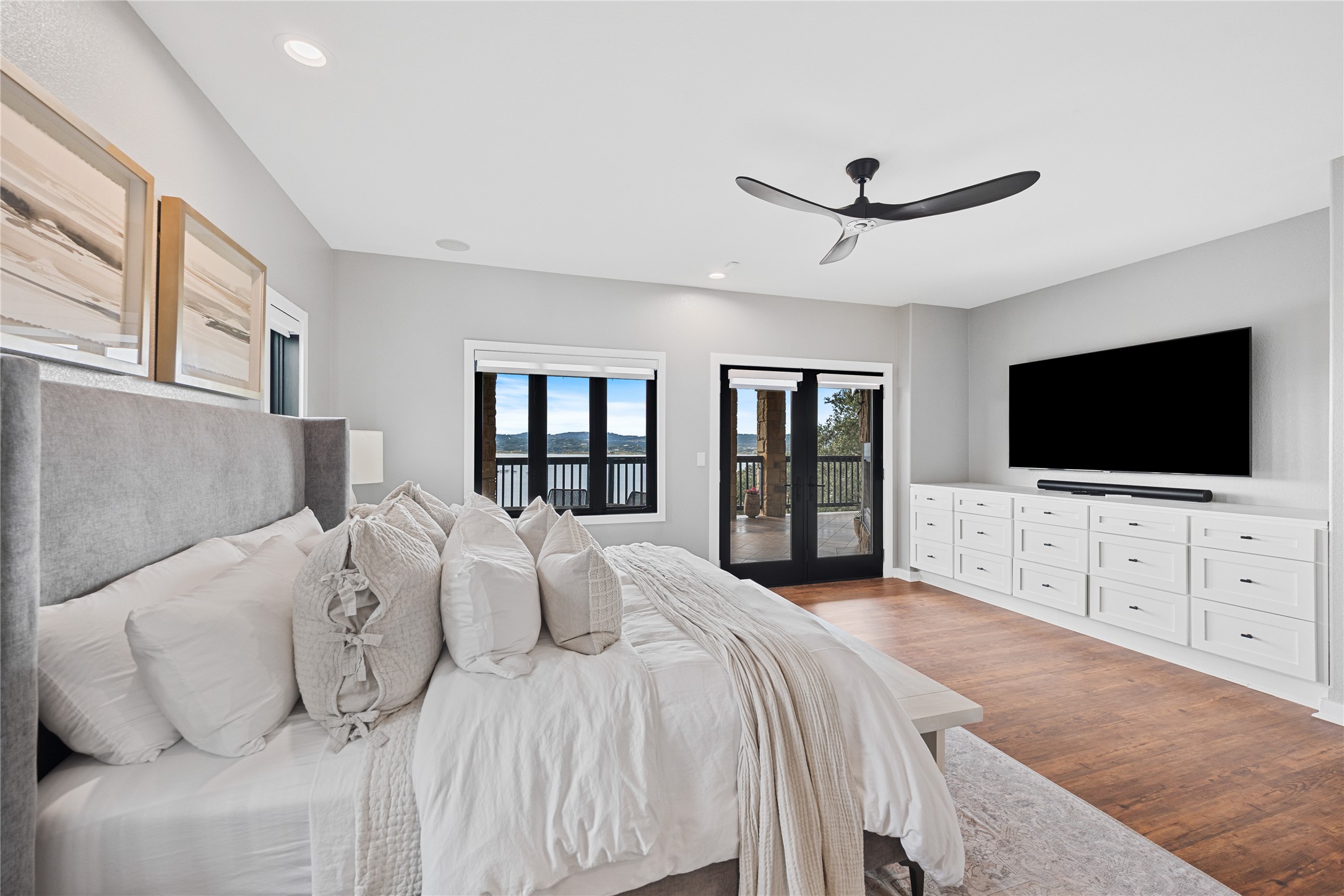 516 Deckhouse Drive Point Venture, TX 78645 - Photo 20 of 36 a bedroom with a large bed and a flat screen tv