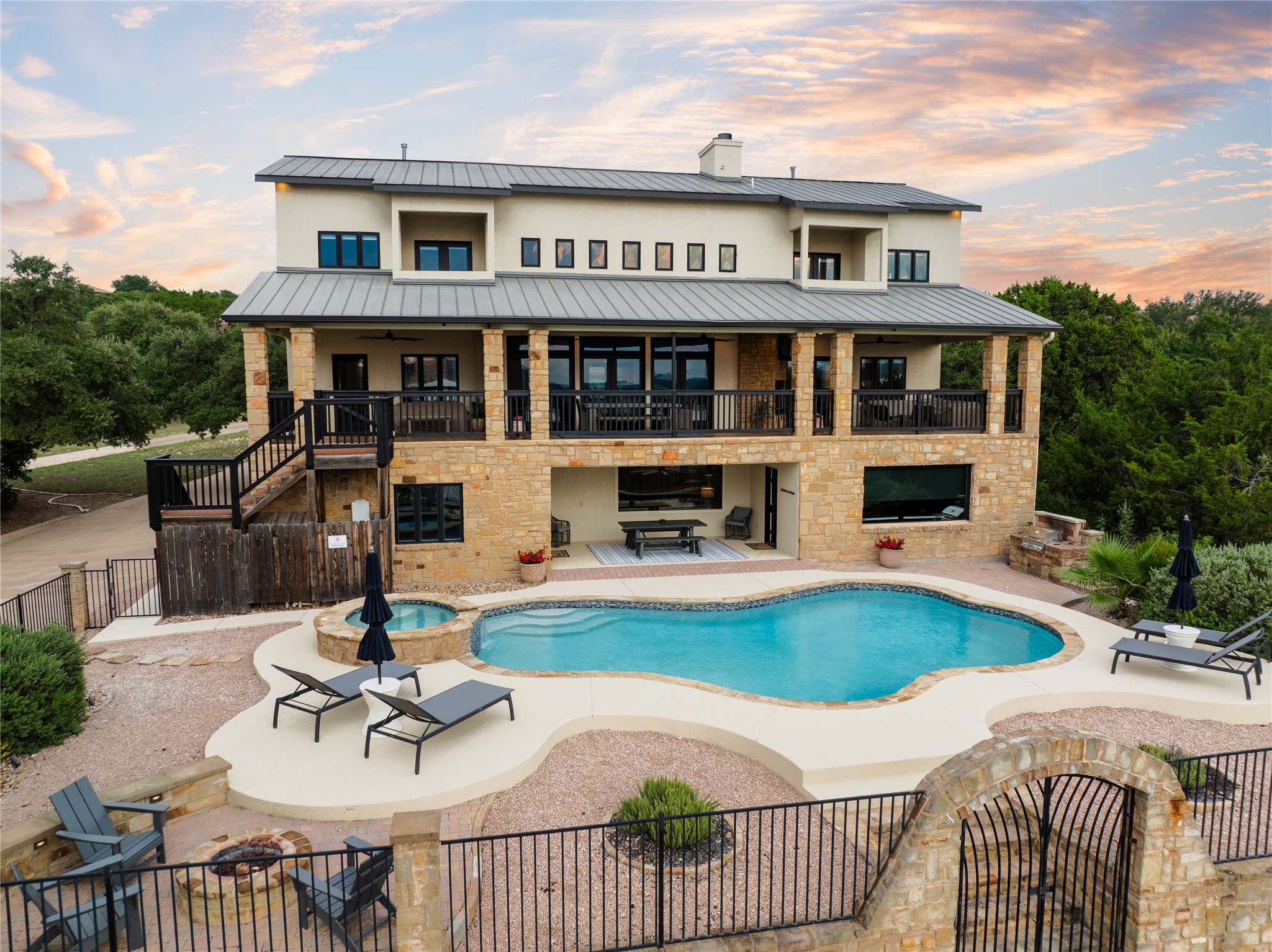 516 Deckhouse Drive Point Venture, TX 78645 - Photo 2 of 36 a front view of a house with swimming pool having outdoor seating